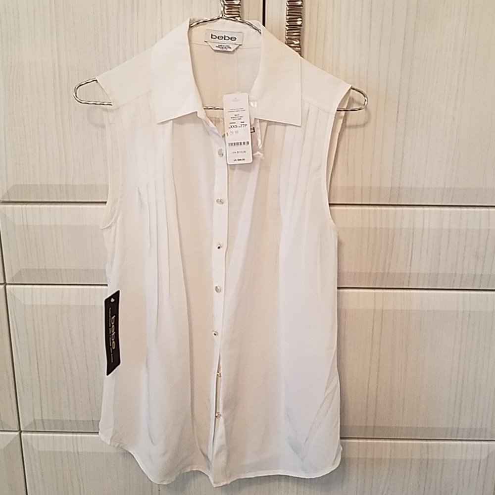 White silk sleeveless bebe blouse